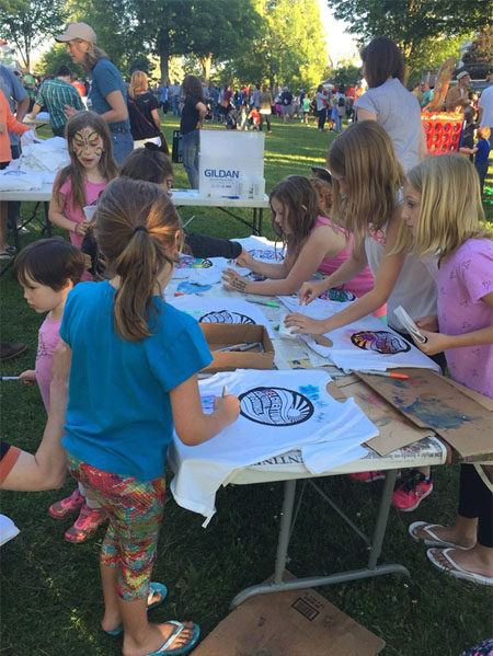 Youg girls color in t-shirts as an art project at the Belchertown Food Truck Festival. Photo by Jen Turner.
